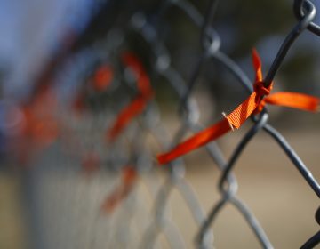 A orange ribbons adorns a fence after it was put there by a student during a walkout to protest gun violence on the soccer field behind Columbine High School Wednesday, March 14, 2018, in Littleton, Colo. More than 250 students took part in the short protest at Columbine, the scene of a mass school shooting on April 20, 1999. (David Zalubowski/AP Photo)