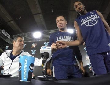 Villanova head coach Jay Wright, left, bumps his fist with Mikal Bridges as Jalen Brunson, center, and Bridges arrive at a news conference with head coach Jay Wright, left, and Mikal Bridges for the championship game of the Final Four NCAA college basketball tournament against Michigan, Sunday, April 1, 2018, in San Antonio.