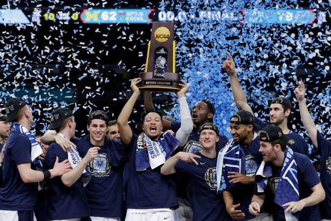 Villanova players celebrate with the trophy after beating Michigan 79-62 in the championship game of the Final Four NCAA college basketball tournament, Monday, April 2, 2018, in San Antonio.
