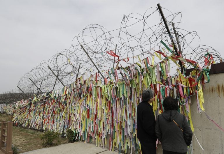 Visitors look at the ribbons carrying messages wishing the reunification and peace of the two Koreas at the Imjingak Pavilion in Paju, South Korea, Saturday, April 7, 2018. North and South Korea have held talks over establishing a telephone hotline between their leaders and other communication issues ahead of a rare summit between the rivals later this month. (Lee Jin-man/AP Photo)