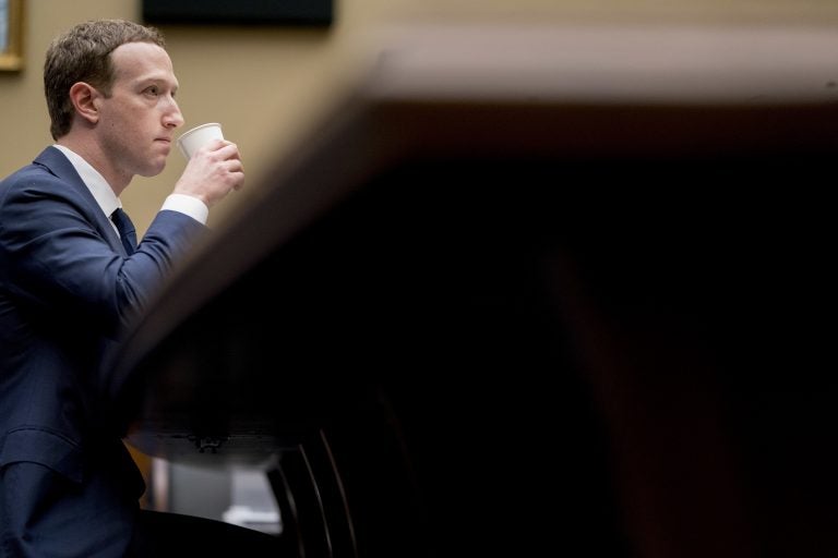 Facebook CEO Mark Zuckerberg drinks water while testifying before a House Energy and Commerce hearing on Capitol Hill in Washington,Wednesday about the use of Facebook data to target American voters in the 2016 election and data privacy. (Andrew Harnik/AP Photo)