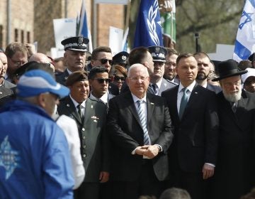 Poland's President Andrzej Duda, (center right), and Israel's President Reuven Rivlin, (center left), walk in the March of the Living, a yearly Holocaust remembrance march between the former Nazi German death camps of Auschwitz and Birkenau, in Oswiecim, Poland, on Thursday, April 12, 2018. (Czarek Sokolowski/AP Photo)
