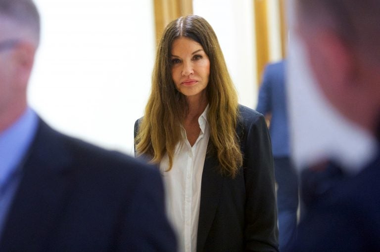 Janice Dickinson walks through the Montgomery County Courthouse during a break in Bill Cosby's sexual assault retrial on Thursday, April 12, 2018, in Norristown, Pa.