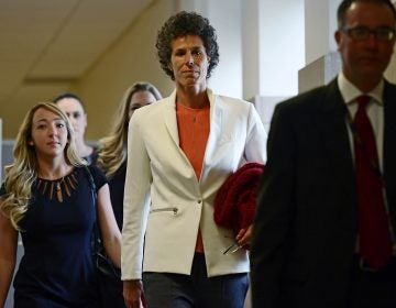 Andrea Constand, center, walks into a courtroom for Bill Cosby's sexual assault trial at the Montgomery County Courthouse, Friday, April 13, 2018, in Norristown, Pa. Constand, Bill Cosby's chief accuser, will take the witness stand on Friday.