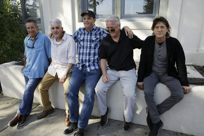 In this Friday, April 13, 2018, photo, the Waldos, from left, Mark Gravitch, Larry Schwartz, Dave Reddix, Jeffrey Noel and Steve Capper sit on a wall they used to frequent at San Rafael High School in San Rafael, Calif. Friday is April 20, or 4/20. That’s the numerical code for marijuana’s high holiday, a celebration and homage to pot’s enduring and universal slang for smoking. And the five Northern California high school stoner buddies widely credited with creating the shorthand slang for getting high nearly 50 years ago now serve as the day's unofficial grand masters.  (Eric Risberg/AP Photo)
