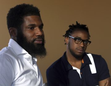 In this Wednesday, April 18, 2018 photo, Rashon Nelson, (left), and Donte Robinson, (right), listen to a reporter's question during an interview with The Associated Press in Philadelphia. Their arrests at a local Starbucks quickly became a viral video and galvanized people around the country who saw the incident as modern-day racism. In the week since, Nelson and Robinson have met with Starbucks CEO Kevin Johnson and are pushing for lasting changes to ensure that what happened to them doesn't happen to future patrons. (Jacqueline Larma/AP Photo)