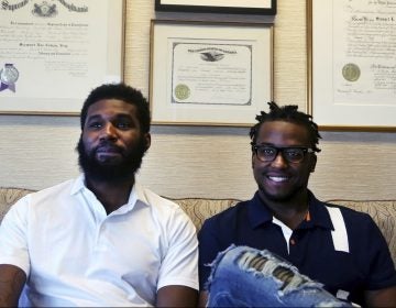 In this Wednesday April 18, 2018 photo, Rashon Nelson, left, and Donte Robinson, right, sit on their attorney's sofa as they pose for a portrait following an interview with The Associated Press in Philadelphia. Their arrests at a local Starbucks quickly became a viral video and galvanized people around the country who saw the incident as modern-day racism. In the week since, Nelson and Robinson have met with Starbucks CEO Kevin Johnson and are pushing for lasting changes to ensure that what happened to them doesn't happen to future patrons. (Jacqueline Larma/AP Photo)