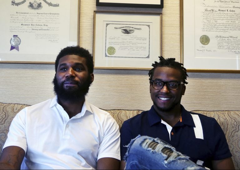 In this Wednesday April 18, 2018 photo, Rashon Nelson, left, and Donte Robinson, right, sit on their attorney's sofa as they pose for a portrait following an interview with The Associated Press in Philadelphia. Their arrests at a local Starbucks quickly became a viral video and galvanized people around the country who saw the incident as modern-day racism. In the week since, Nelson and Robinson have met with Starbucks CEO Kevin Johnson and are pushing for lasting changes to ensure that what happened to them doesn't happen to future patrons. (Jacqueline Larma/AP Photo)