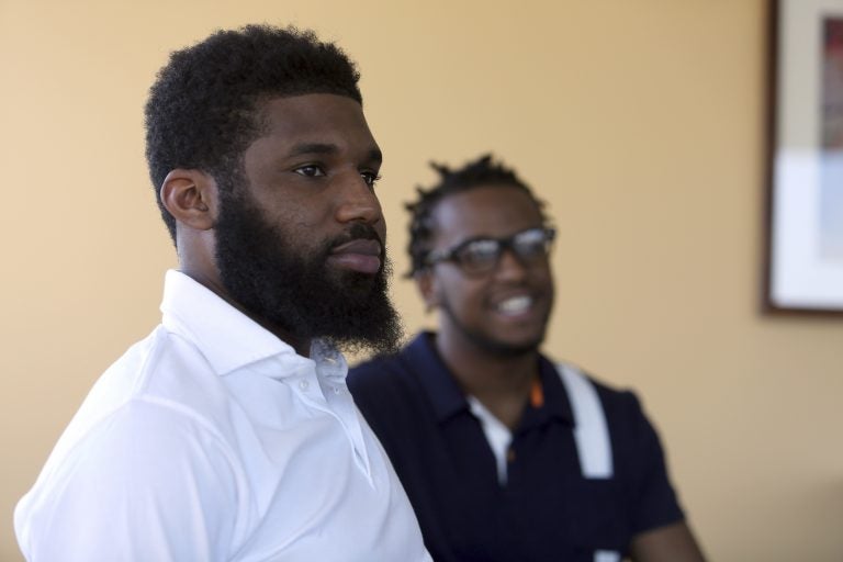 Rashon Nelson, listens to a reporter's question alongside Donte Robinson during an interview with the Associated Press Wednesday April 18, 2018 in Philadelphia.