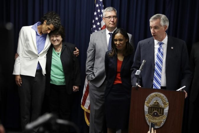 District Attorney Kevin Steele, right, speaks at a news conference as accuser Andrea Constand, left, embraces her attorney Dolores Troiani after Bill Cosby was found guilty in his sexual assault trial, Thursday, April 26, 2018, in Norristown, Pa. Cosby stared straight ahead as the verdict was read but moments later lashed out loudly at Steele after the prosecutor demanded Cosby be sent immediately to jail. Steele told the judge Cosby has an airplane and might flee. (AP Photo/Matt Slocum)