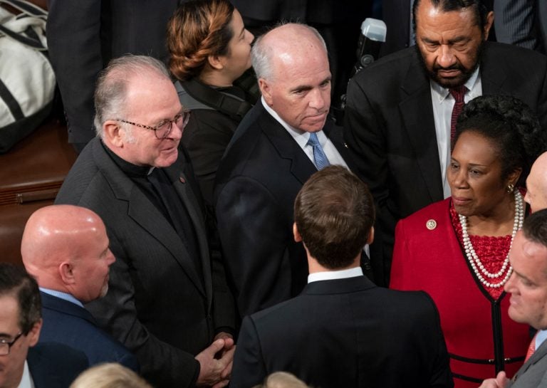 Chaplain of the House of Representatives Father Patrick J. Conroy, upper left, speaks with French President Emmanuel Macron, bottom enter, at the Capitol in Washington, Wednesday, April 25, 2018. (AP Photo/J. Scott Applewhite)