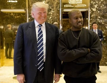 President-elect Donald Trump, left, and Kanye West pose for a picture in the lobby of Trump Tower in New York in 2016. (AP Photo/Seth Wenig)