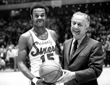 Hal Greer (15), of the Philadelphia 76ers, accepts ball from Sixers owner Irv Koslof