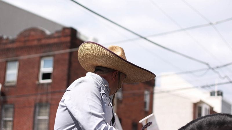 To commemorate the 19th century Battle of Puebla, participants in the Carnaval dress as French and Spanish soldiers while riding through South Philadelphia on horseback. (Angela Gervasi for WHYY)