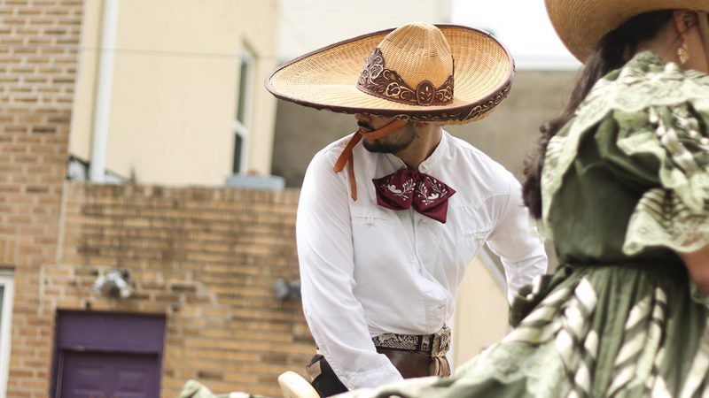 Participants in the Carnaval de Puebla dress as French and Spanish soldiers while riding through South Philadelphia on horseback to commemorate the 19th century Battle of Puebla. (Angela Gervasi for WHYY).