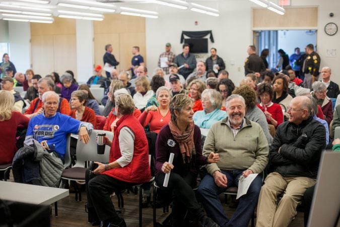 New Castle County residents debate guns and gun policy at a town hall with U.S Sen. Tom Carper and U.S Rep. Lisa Blunt Rochester (both D-Del.) Saturday morning. (Brad Larrison for WHYY)