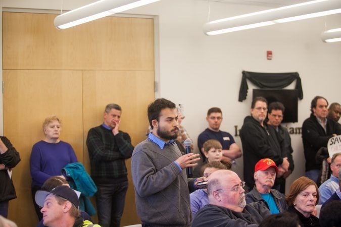 Wilmington resident Alex Lindstrom highlighted statistics related to the types of firearms used in the majority of shootings in the United States at a town hall on guns and gun violence Saturday morning in New Castle, Del. (Brad Larrison for WHYY)