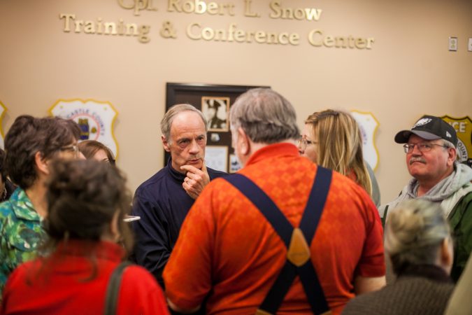 U.S Sen. Tom Carper (D-Del.) speaks with constituents about guns  following a town hall Saturday morning in New Castle. (Brad Larrison for WHYY)