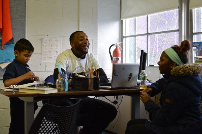 Jovan hangs out with Jace and Ariel in his office before the school day begins. (Kevin McCorry/WHYY)