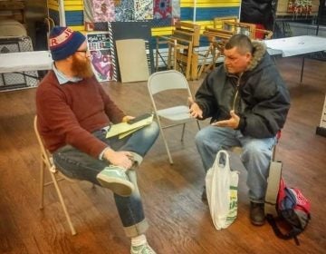 The Renegade Company's Mike Durkin (left) collecting a resident's story (Dennis Payne)