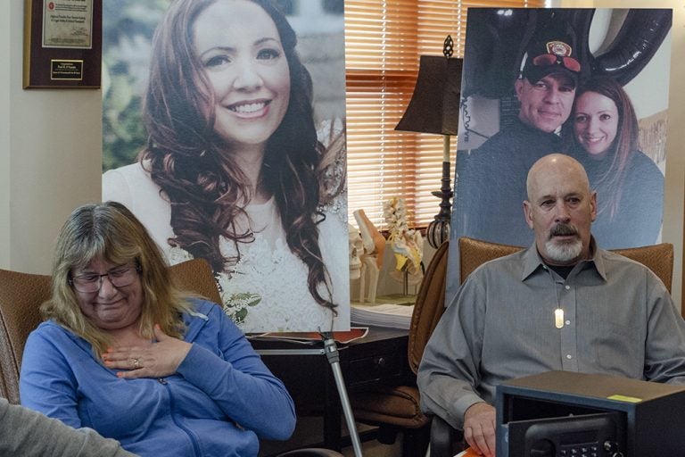 Carol McDowell gets emotional as she and Kevin McDowell sit in front of photos of their daughter Kelly Ann McDowell during a press conference. McDowell killed herself with the service revolver of her boyfriend, Ventnor Police Sgt. Frank O'Neill.