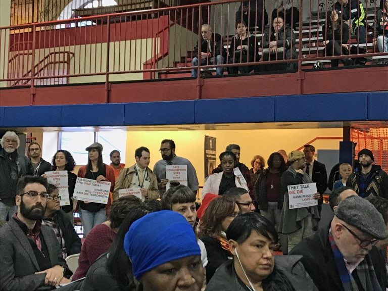 Demonstrators hold signs showing their support for a supervised injection facility for drug users in Philadelphia. (Joel Wolfram/WHYY)