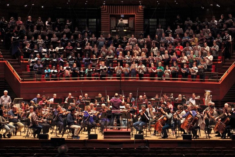 FILE - The Philadelphia Orchestra teams up with 250 singers from four choirs during a rehearsal for 'Philadelphia Voices' at the Kimmel Center. (Emma Lee/WHYY)