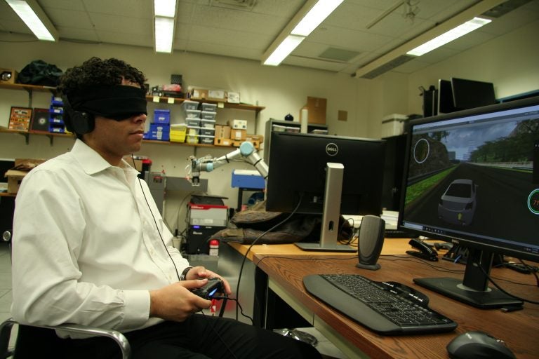 Brian Smith plays a racing game blindfolded. He made a user interface for blind players to drive in video games, just like sighted players. He tested it with blind volunteers, as well as blindfolded sighted volunteers.