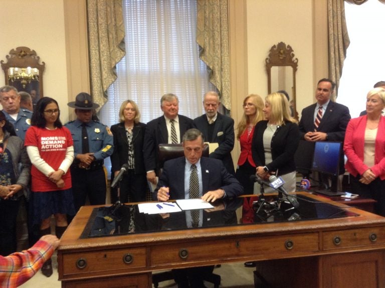 Delaware Gov. John Carney signs legislation Wednesday that raises the maximum sentence for the illegal purchase, transfer or possession of a firearm. (Zoe Read/WHYY)