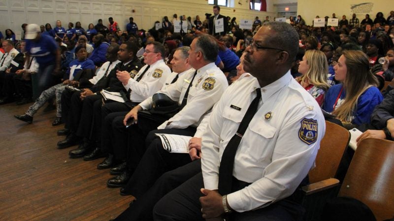 Representatives of the Philadelphia police department attend an assembly at Mastery Shoemaker Charter School focused on reducing gun violence. (Emma Lee/WHYY)