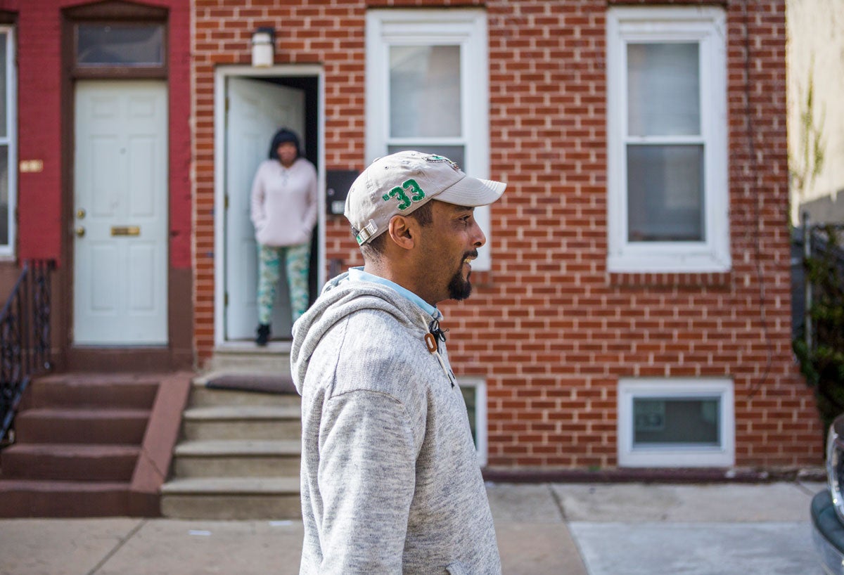 Jovan Weaver walks by his old house in Strawberry Mansion (Jessica Kourkounis/WHYY)