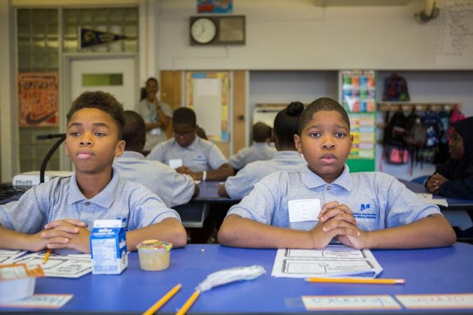 Students in Hayes' English class fold their hands in attention. If students were focused and attentive, Hayes' class would be breezy and casual. If students started to disconnect from the work, he was strict about calling for attention. (Jessica Kourkounis/WHYY)