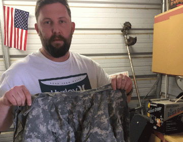 Veteran Thomas Fitzinge holding his uniform. (Provided)