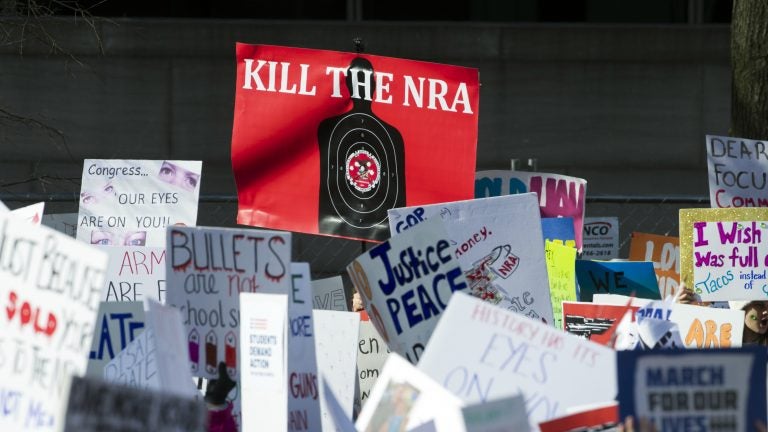 Protesters hold signs aloft as they attend the March for Our Lives rally in support of gun control in Washington, D.C., last month. (Cliff Owen/AP)