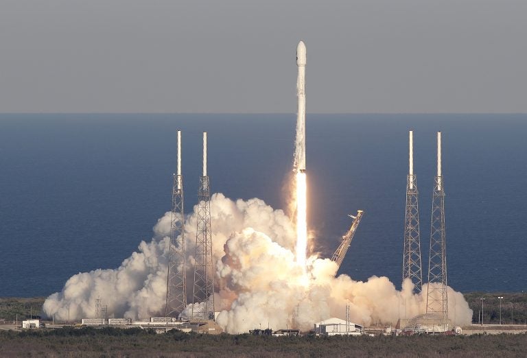 A SpaceX Falcon 9 rocket transporting the TESS satellite lifts off at the Cape Canaveral Air Force Station in Florida on Wednesday. The satellite will scan nearly the entire sky for alien worlds. (John Raoux/AP)