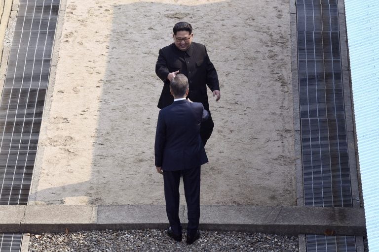 Hand out, North Korean leader Kim Jong Un approaches South Korean President Moon Jae-in at the border village of Panmunjom in the Demilitarized Zone on Friday. (Korea Summit Press Pool via AP)