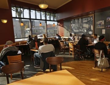 Customers sit in a Starbucks store in Seattle.
(Ted S. Warren/AP)