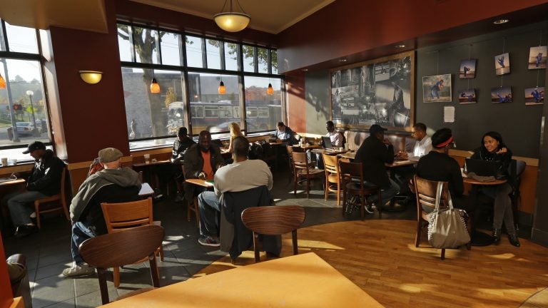 Customers sit in a Starbucks store in Seattle.
(Ted S. Warren/AP)