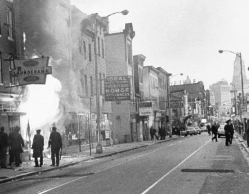 Fire shoots out from a Baltimore store on Gay Street as looting erupted in a five-block business section in Baltimore on April 6, 1968. Police sealed off the area. (AP)