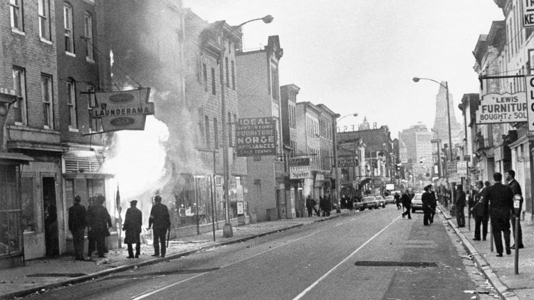 Fire shoots out from a Baltimore store on Gay Street as looting erupted in a five-block business section in Baltimore on April 6, 1968. Police sealed off the area. (AP)