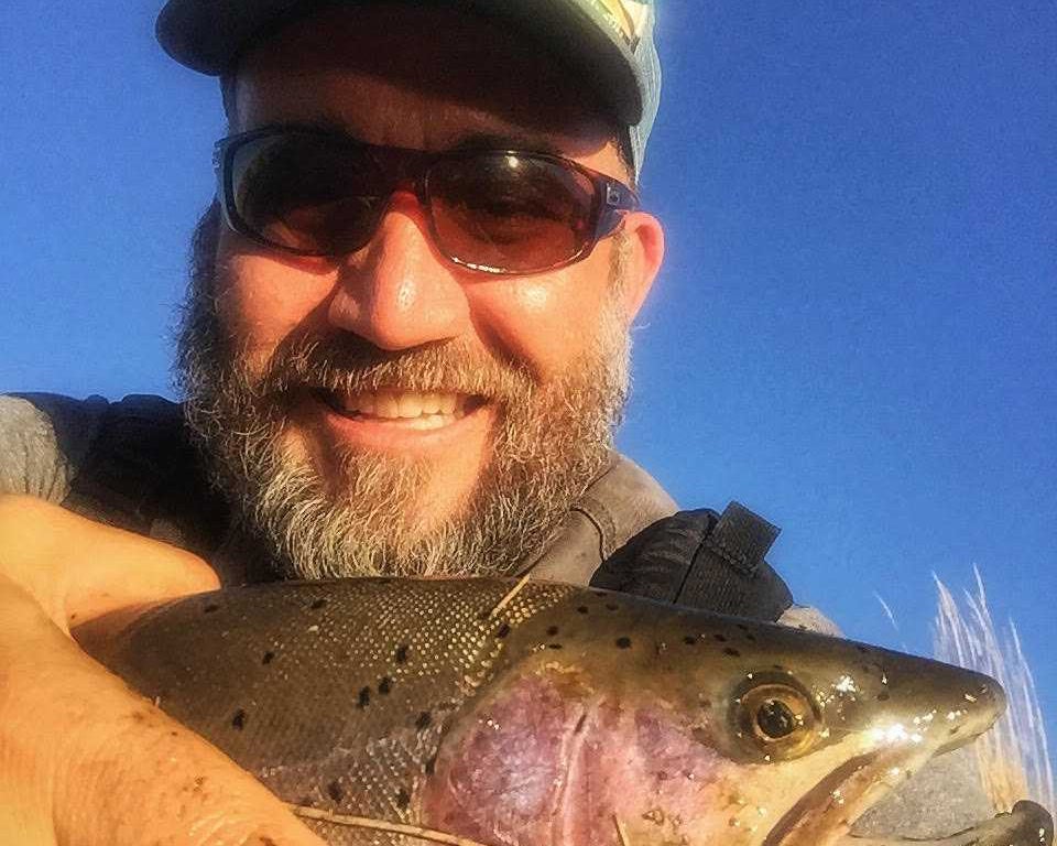 Matt Vincent poses with a fish. He loves fishing, and wants to preserve the environment. But he hesitates to call himself an environmentalist. Photo courtesy of Matt Vincent.