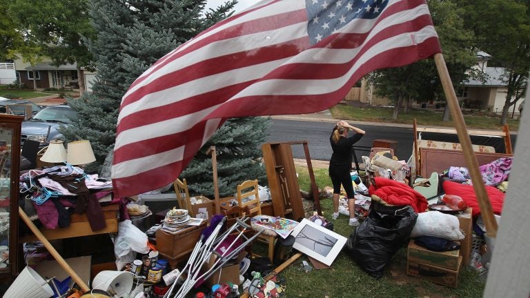 Julie Holzhauer stands among her family's possessions after being evicted from her home in Centennial, Colo., in 2011. (John Moore/Getty Images) 