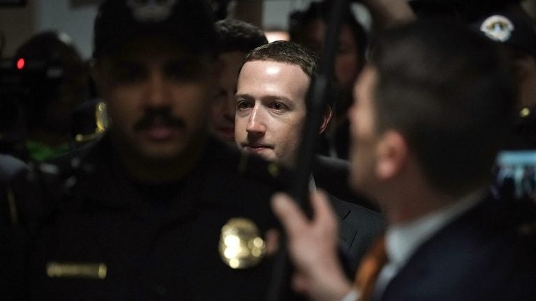 Facebook CEO Mark Zuckerberg is escorted by police on his way to a meeting Monday with U.S. Sen. Dianne Feinstein, D-Calif., ranking member of the Senate Judiciary Committee. (Alex Wong/Getty Images)
