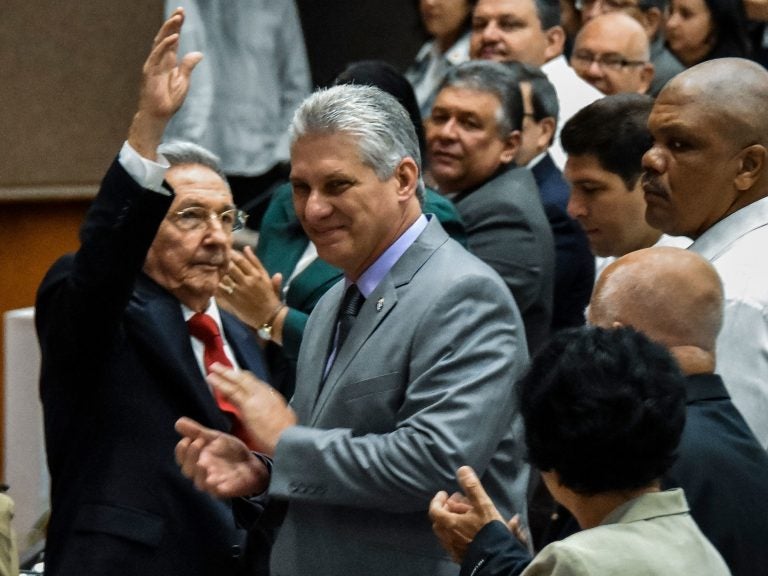 Cuban President Raul Castro waves to the room as First Vice President Miguel Diaz-Canel, Castro's handpicked successor, claps at the National Assembly session Wednesday in Havana. (STR/AFP/Getty Images)