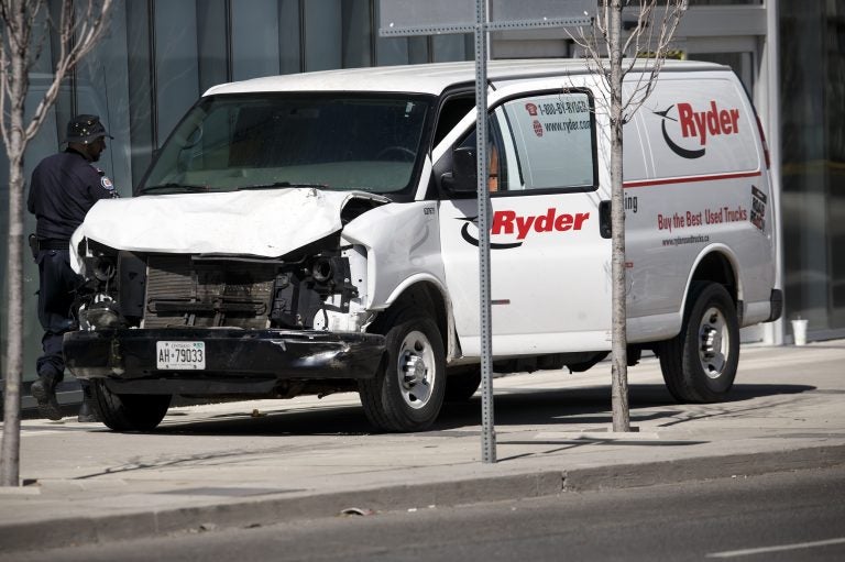 Police inspect a van suspected of being involved in a collision that killed at least nine people and injured 16 others in Toronto on Monday. Police inspect a van suspected of being involved in a collision that killed at least 10 people and injured 15 others in Toronto on Monday. (Cole Burston/Getty Images)