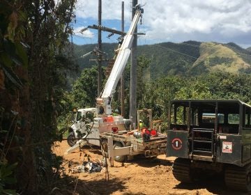 Contractors working to restore power in Cayey, Puerto Rico, last week, the same region where a falling tree interrupted a main transmission line Thursday, plunging 840,000 customers into darkness. (Adrian Florido/NPR)