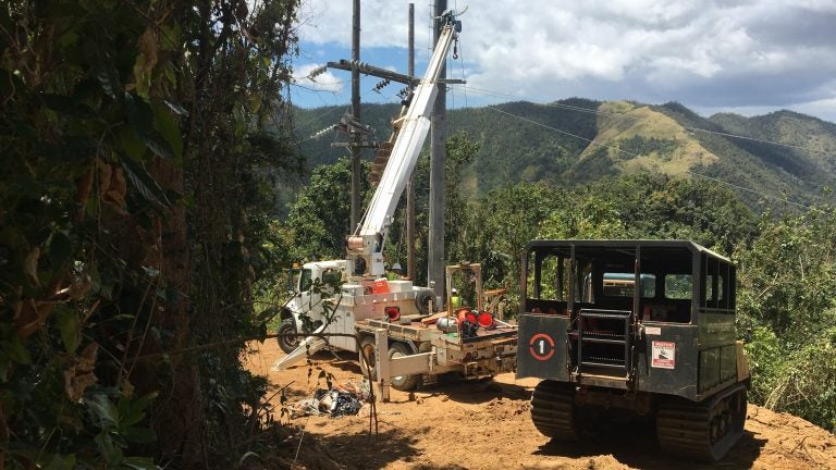 Contractors working to restore power in Cayey, Puerto Rico, last week, the same region where a falling tree interrupted a main transmission line Thursday, plunging 840,000 customers into darkness. (Adrian Florido/NPR)