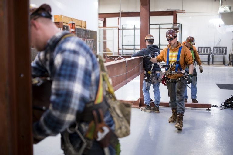 Garret Morgan (center) is training as an ironworker near Seattle and already has a job that pays him $50,000 a year. (Sy Bean/The Hechinger Report)