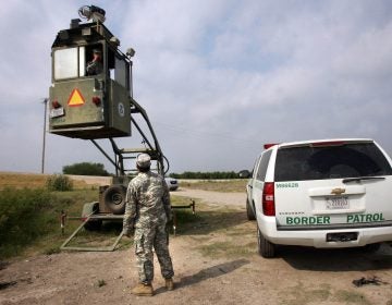 A member of the National Guard checks on his colleague inside a Border Patrol Skybox near the U.S.-Mexico border in Hidalgo, Texas, in this 2011 photo. President Trump is calling for troops on the southern border, something the last five presidents have all done.
(Delcia Lopez/AP)