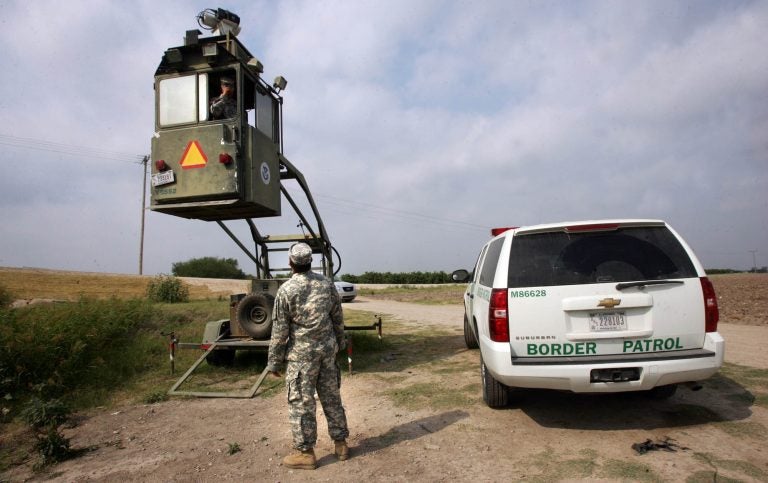 A member of the National Guard checks on his colleague inside a Border Patrol Skybox near the U.S.-Mexico border in Hidalgo, Texas, in this 2011 photo. President Trump is calling for troops on the southern border, something the last five presidents have all done.
(Delcia Lopez/AP)